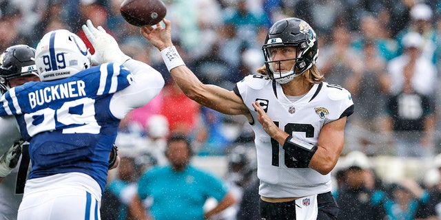 Quarterback Trevor Lawrence, #16 of the Jacksonville Jaguars, throws a pass over DeForest Buckner, #99 of the Indianapolis Colts, during the game at TIAA Bank Field on Sept. 18, 2022 in Jacksonville, Florida.