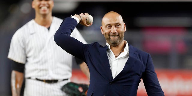 Baseball Hall of Famer Derek Jeter throws the ceremonial first pitch as Frankie Montas of the New York Yankees looks on before a game against the Tampa Bay Rays at Yankee Stadium Sept. 9, 2022, in the Bronx borough of New York City. 