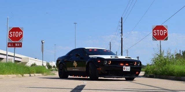 The Dodge was converted into a black and white highway patrol vehicle, equipped with emergency lights and a police radio.