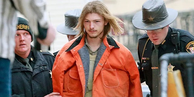 Edward "Jake" Wagner being escorted by police officers into Pike County Court in Waverly, Ohio, in 2018.