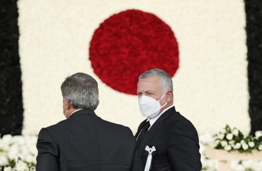 King of Jordan Abdullah II bin Al-Hussein (right) walks after offering flowers during the state funeral for Shinzo Abe in Tokyo, Japan Sept. 27, 2022.
