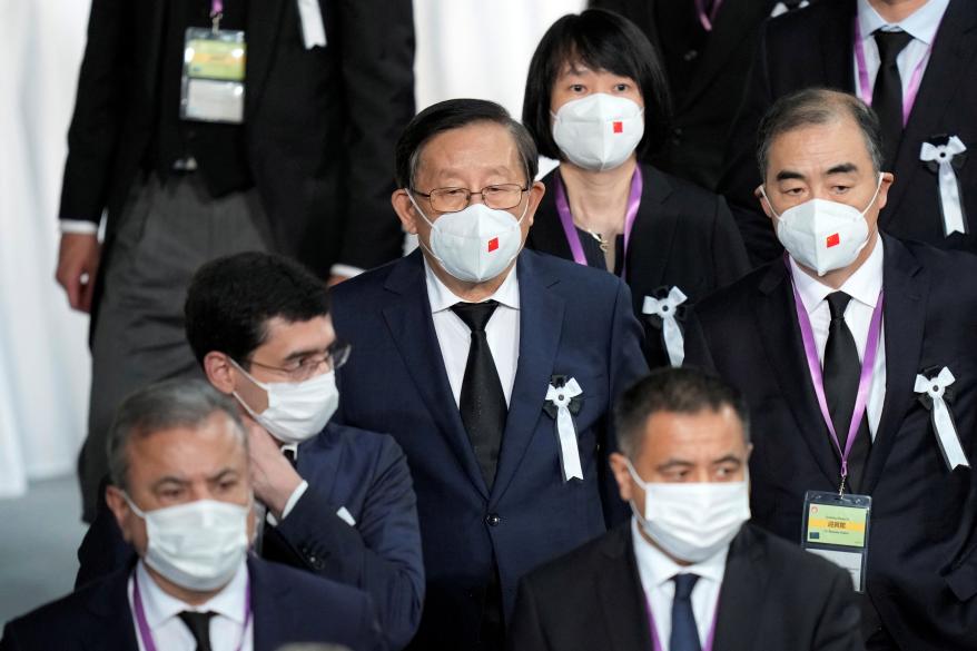 China’s representative Wan Gang, center, attends the state funeral of assassinated former Prime Minister of Japan Shinzo Abe on Sept. 27, 2022 in Tokyo.