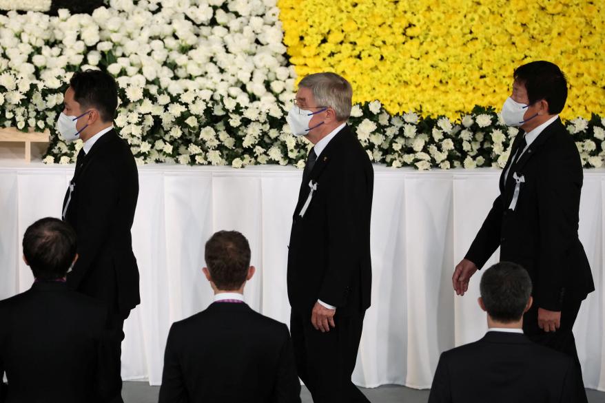 International Olympic Committee President Thomas Bach (center) pays his respects during the state funeral for Shinzo Abe on Sept. 27, 2022 in Tokyo, Japan.