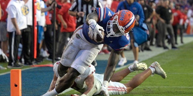 Florida running back Montrell Johnson Jr. is pushed out of bounds just short of the goal line by Utah safety Cole Bishop, Saturday, Sept. 3, 2022, in Gainesville.