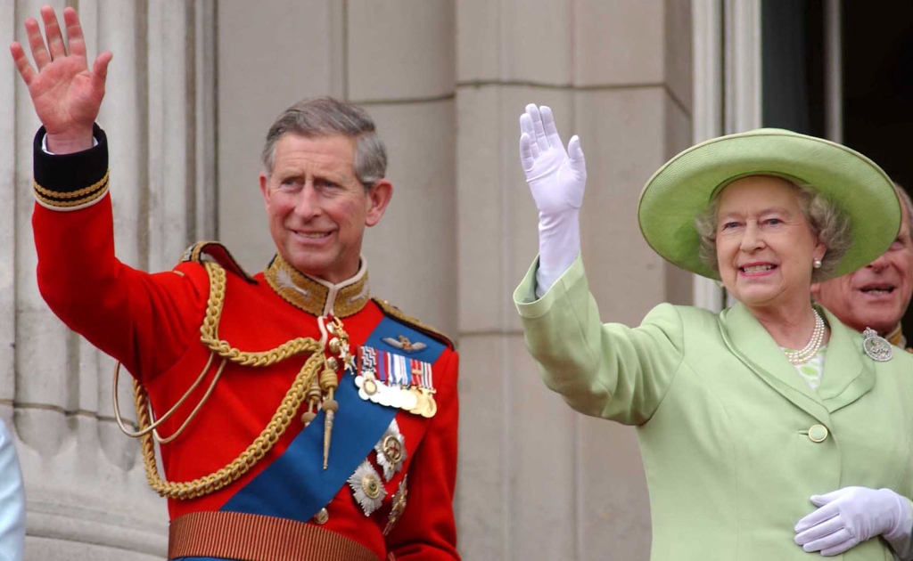 Queen Elizabeth II and her son Prince Charles wave from Buckingham Palace on June 15, 2002 after the annual "Trooping The Colour" ceremony.