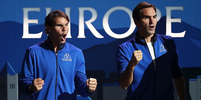 Rafael Nadal of Team Europe, left, and teammate Roger Federer celebrate during a singles match between Stefanos Tsitsipas of Team Europe and Taylor Fritz of Team World during the Laver Cup 2019 at Palexpo Sept. 20, 2019, in Geneva, Switzerland. 