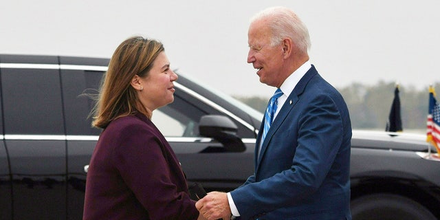 Rep. Elissa Slotkin greets US President Joe Biden upon arrival at Capital Region International Airport in Lansing, Michigan, on October 5, 2021.