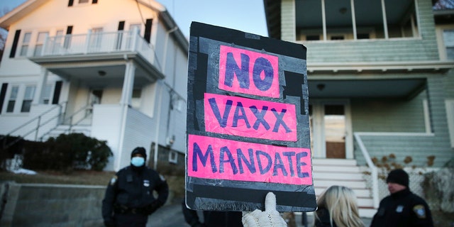 A group of demonstrators protest outside the home of Boston Mayor Michelle Wu in the Roslindale neighborhood of Boston on January 25, 2022. 