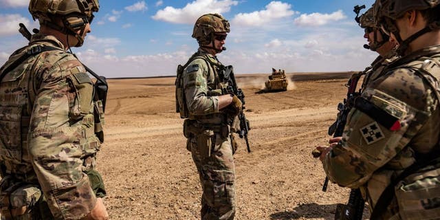 Troops from the Syrian Democratic Forces (SDF) Special Operations and the U.S.-led anti-jihadist coalition, take part in heavy-weaponry military exercises in the countryside of Deir Ezzor in northeastern Syria, on March 25, 2022.