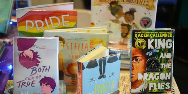 Children's books that are fighting for survival at public schools because of their LGBTQ content are displayed at the annual Pride Town Hall at Walter Johnson High School in Bethesda, Md., May 21, 2022.