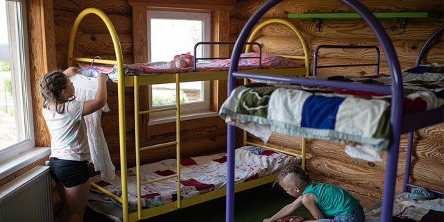 KYIV, UKRAINE - JUNE 20: Children unpack on June 20, 2022 near Kyiv, Ukraine. The goal of the 7fields camp, which is near Zalissia National Nature Park, is to support the children of families displaced from other parts of Ukraine since the February 24 invasion, but who are remaining in the country. Over the summer, the camp aims to support 300 children between the ages of 7 and 15, with activities like swimming pools, tennis, soccer, yoga, chess and craft-making, in addition to therapy sessions. (Photo by Alexey Furman/Getty Images)