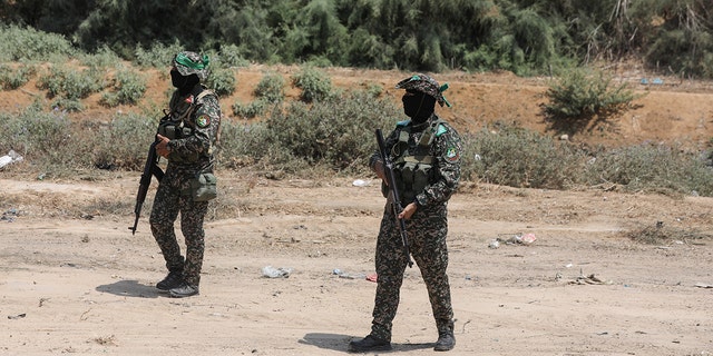 Masked members of the al-Qassam Brigades, during a funeral at al-Bureij refugee camp in the central Gaza strip, on August 8, 2022.  