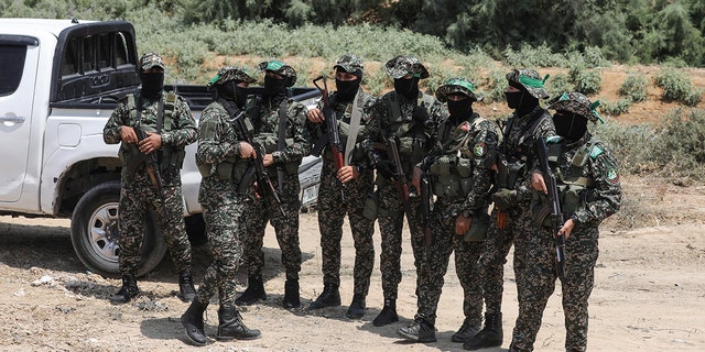 Masked members of the al-Qassam Brigades, the military wing of Hamas, in the central Gaza strip, on August 8, 2022.  