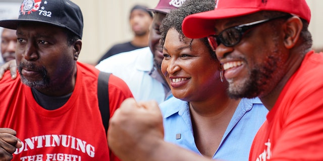 Democratic gubernatorial candidate for Georgia, Stacey Abrams, poses for photos at a Labor Day picnic on September 5, 2022, in Atlanta.