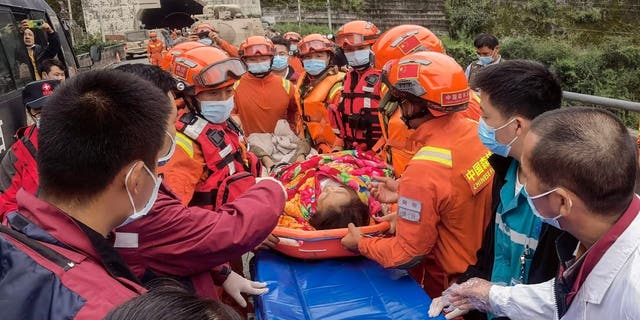 Rescue workers carry an injured person after a 6.6-magnitude earthquake in Luding county, Ganzi Prefecture in China's southwestern Sichuan province on September 6, 2022