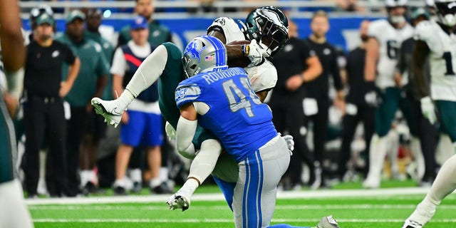 Detroit Lions linebacker Malcolm Rodriguez (44) upends Philadelphia Eagles running back Miles Sanders (26) during a game Sunday, Sept. 11, 2022, at Ford Field in Detroit. 