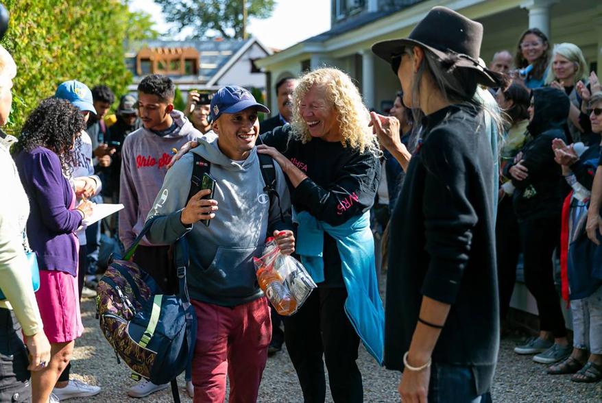 A Venezuelan migrant reacts as he is led onto a bus at St. Andrews Episcopal Church in Edgartown, Mass. on the island of Martha's Vineyard.