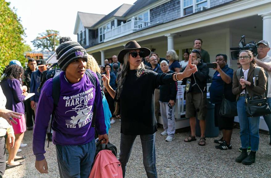 A Venezuelan migrant is led to the bus at St. Andrews Episcopal Church on Sept. 16, 2022, in Edgartown, Mass. on the island of Martha's Vineyard.