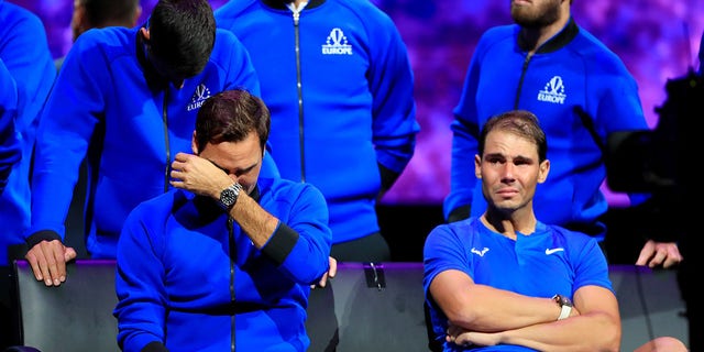 Team Europe player Roger Federer of Switzerland front L, Rafael Nadal front R of Spain, Novak Djokovic 1st L, Rear of Serbia react at the end of Roger Federer's last match after Federer announced his retirement at the Laver Cup in London, Britain, Sept. 24, 2022. 