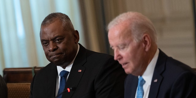 Secretary fo Defense Lloyd Austin, left, as President Biden speaks during a meeting of the White House Competition Council in the State Dining Room in Washington, D.C., on Monday, Sept. 26, 2022. 