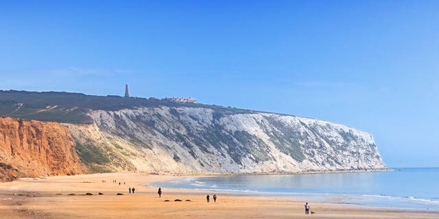 Yaverland Beach on the Isle of Wight with Culver Down Cliff jutting out to sea.