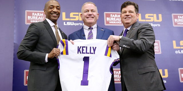 Brian Kelly, center, is introduced as the head football coach of the LSU Tigers by LSU President William F. Tate IV, left, and athletics director Scott Woodward during a news conference at Tiger Stadium in Baton Rouge, Louisiana, on Dec. 1, 2021.