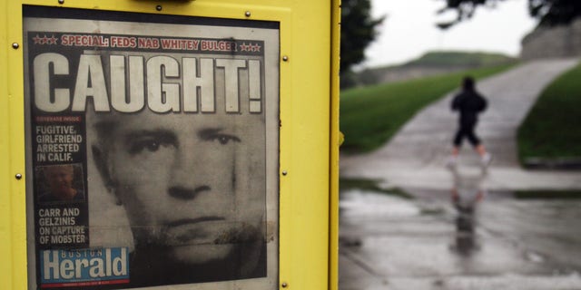 The early morning scene at Southie's Castle Island, Boston, shows a June 23, 2011, newspaper announcing the capture of James Whitey Bulger.