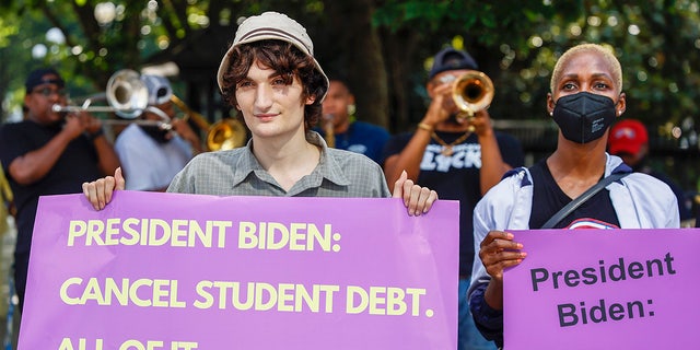 WASHINGTON, DC - JULY 27:  Student loan debt holders take part in a demonstration outside of the white house staff entrance to demand that President Biden cancel student loan debt in August on July 27, 2022 at the Executive Offices in Washington, DC. (Photo by Jemal Countess/Getty Images for We, The 45 Million)