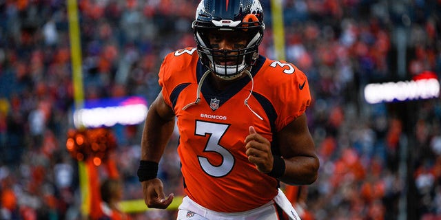 Quarterback Russell Wilson, #3 of the Denver Broncos, runs onto the field before a preseason NFL game against the Minnesota Vikings at Empower Field at Mile High on August 27, 2022, in Denver. 