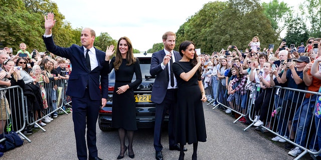 Catherine, Princess of Wales, Prince William, Prince of Wales, Prince Harry, Duke of Sussex, and Meghan, Duchess of Sussex wave to crowd on the long Walk at Windsor Castle on Sept. 10, 2022 in Windsor, England. 