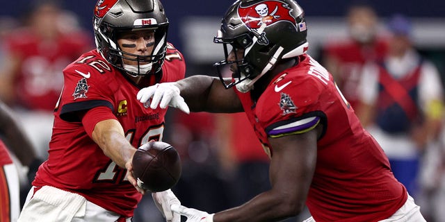 Tom Brady of the Tampa Bay Buccaneers hands the ball off to Leonard Fournette during the Dallas Cowboys game on Sept. 11, 2022, in Arlington, Texas.