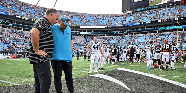 Head coach Matt Rhule (in blue shirt) of the Carolina Panthers pauses for a brief prayer after a loss to the Cleveland Browns at Bank of America Stadium in Charlotte, North Carolina, on Sept. 11, 2022.