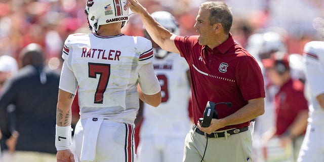 Head coach Shane Beamer talks with Spencer Rattler (7) of the South Carolina Gamecocks during a game against the Arkansas Razorbacks at Donald W. Reynolds Razorback Stadium Sept. 10, 2022, in Fayetteville, Ark.