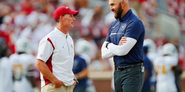 Head coach Brent Venables of the Oklahoma Sooners, left, talks with head coach Sean Lewis of the Kent State Golden Flashes before their game at Gaylord Family Oklahoma Memorial Stadium Sept. 10, 2022, in Norman, Oka. Oklahoma won 33-3. 