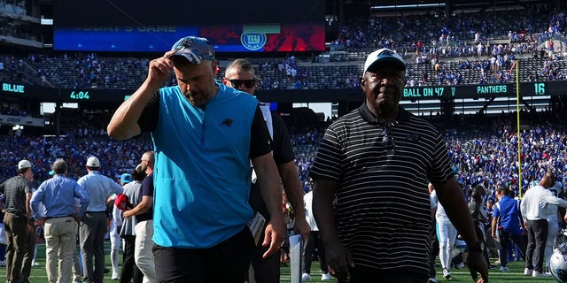 Head coach Matt Rhule, left, of the Carolina Panthers walks off the field after the game against the New York Giants at MetLife Stadium in East Rutherford, New Jersey, on Sept. 18, 2022.