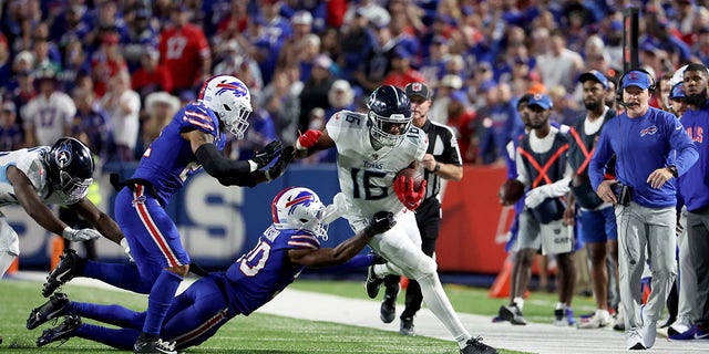 Treylon Burks of the Tennessee Titans runs with the ball against Dane Jackson of the Buffalo Bills on Sept. 19, 2022, in Orchard Park, New York. 