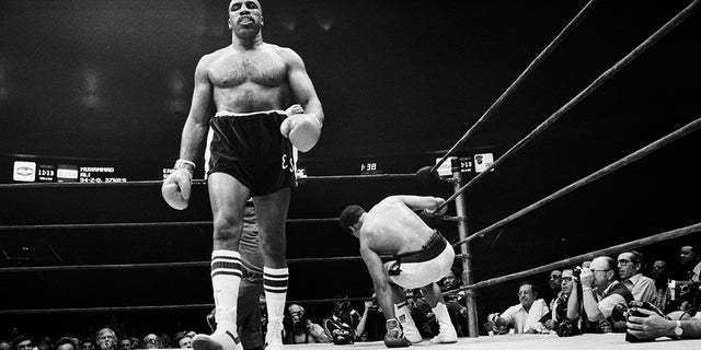 Ali slips in the 14th round as Shavers walks to a neutral corner during their heavyweight title bout.