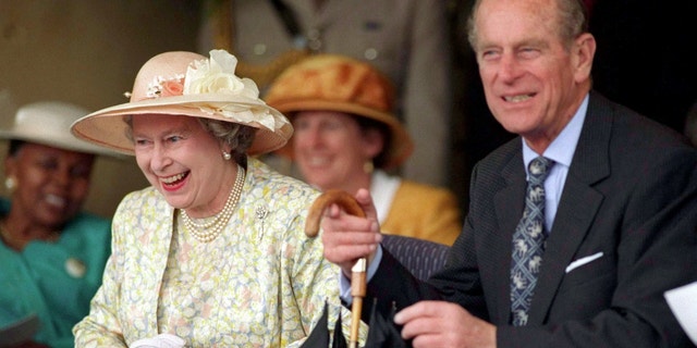 Queen Elizabeth seen laughing with Prince Philip during a trip to South Africa in 1995.