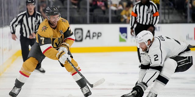 Vegas Golden Knights defenseman Alex Pietrangelo (7) passes around Los Angeles Kings defenseman Alexander Edler (2) during the second period of an NHL preseason hockey game Monday, Sept. 26, 2022, in Las Vegas.