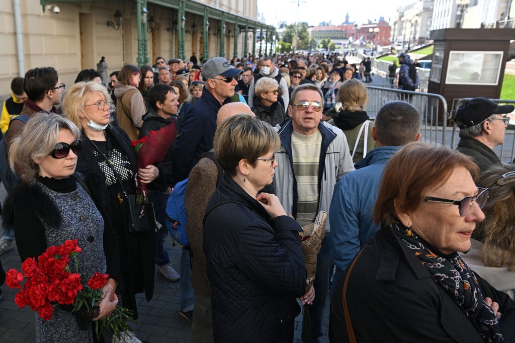 People stand in line to attend a farewell ceremony in front of the building of the Hall of Columns, where a farewell ceremony for Mikhail Gorbachev is taking place in Moscow on Sept. 3, 2022.