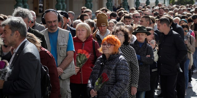 People line up to pay the last respects at the coffin of former Soviet President Mikhail Gorbachev outside the Pillar Hall of the House of the Unions during a farewell ceremony in Moscow, Russia, Saturday, Sept. 3, 2022.