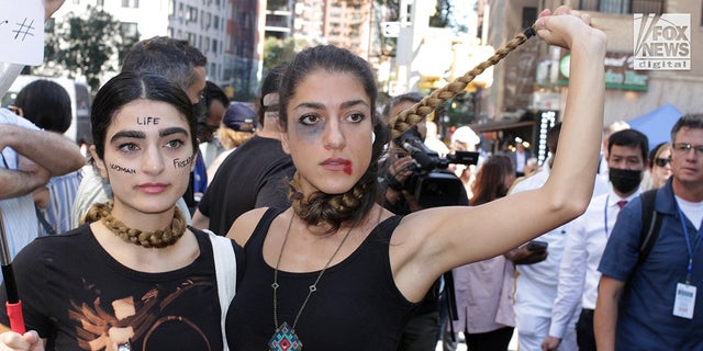 Two women vividly demonstrate their disdain for the current Iranian regime during a protest in Dag Hammerskjold Park across from the U.N. headquarters. 