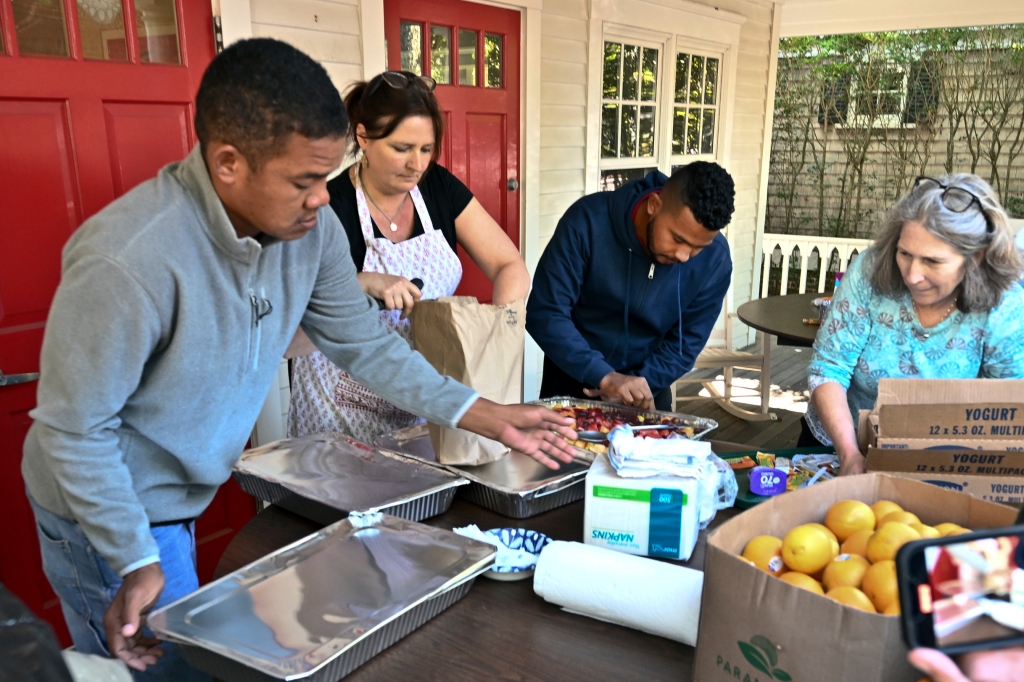 Volunteers prepare food for immigrants outside St. Andrews Episcopal Church on Sept. 15, 2022, in Edgartown, Mass.