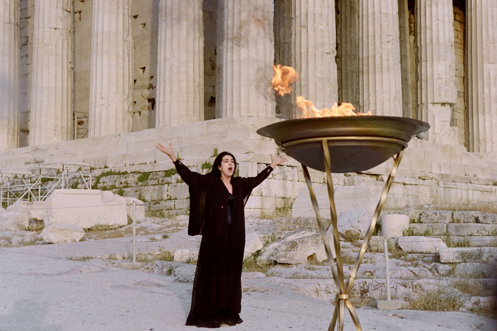 Papas recites an ancient Greek poem to the Olympic flame in front of the Acropolis in Athens on June 7, 1992.