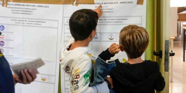 Lists of candidates as displayed at a polling station in Rome, Sunday, Sept. 25, 2022. Italians were voting on Sunday in an election that could move the country's politics sharply toward the right during a critical time for Europe, with war in Ukraine fueling skyrocketing energy bills and testing the West's resolve to stand united against Russian aggression. (AP Photo/Gregorio Borgia)