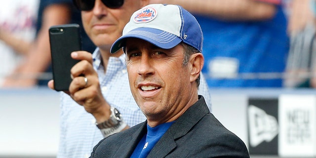 Comedian Jerry Seinfeld looks on before throwing the ceremonial first pitch of a game between the New York Mets and the Philadelphia Phillies at Citi Field on July 05, 2019, in New York City.