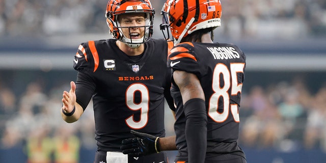 Cincinnati Bengals quarterback Joe Burrow (9) celebrates a first down with wide receiver Tee Higgins during the second half against the Dallas Cowboys in Arlington, Texas, on Sept. 18, 2022.