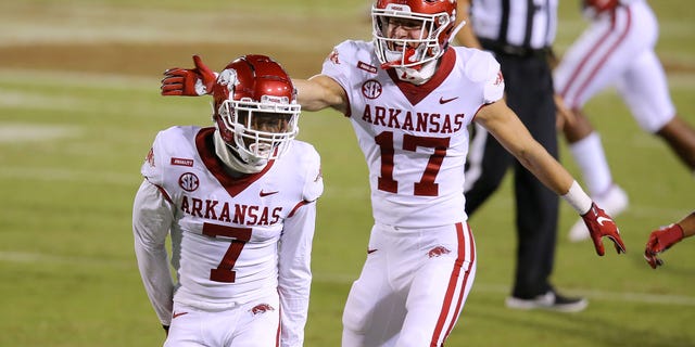 Joe Foucha #7 of the Arkansas Razorbacks celebrates an interception with J.T. Towers #17 during the second half against the Mississippi State Bulldogs at Davis Wade Stadium on October 03, 2020 in Starkville, Mississippi.