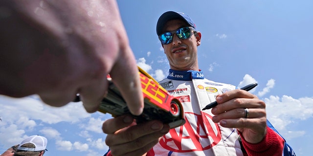 Joey Logano gives autographs before the Autotrader EchoPark Automotive 500 at Texas Motor Speedway in Fort Worth, Texas, on Sept. 25, 2022.