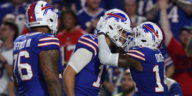 Stefon Diggs #14 of the Buffalo Bills celebrates with teammate Josh Allen #17 after scoring a touchdown against the Tennessee Titans during the third quarter of the game at Highmark Stadium on September 19, 2022 in Orchard Park, New York.